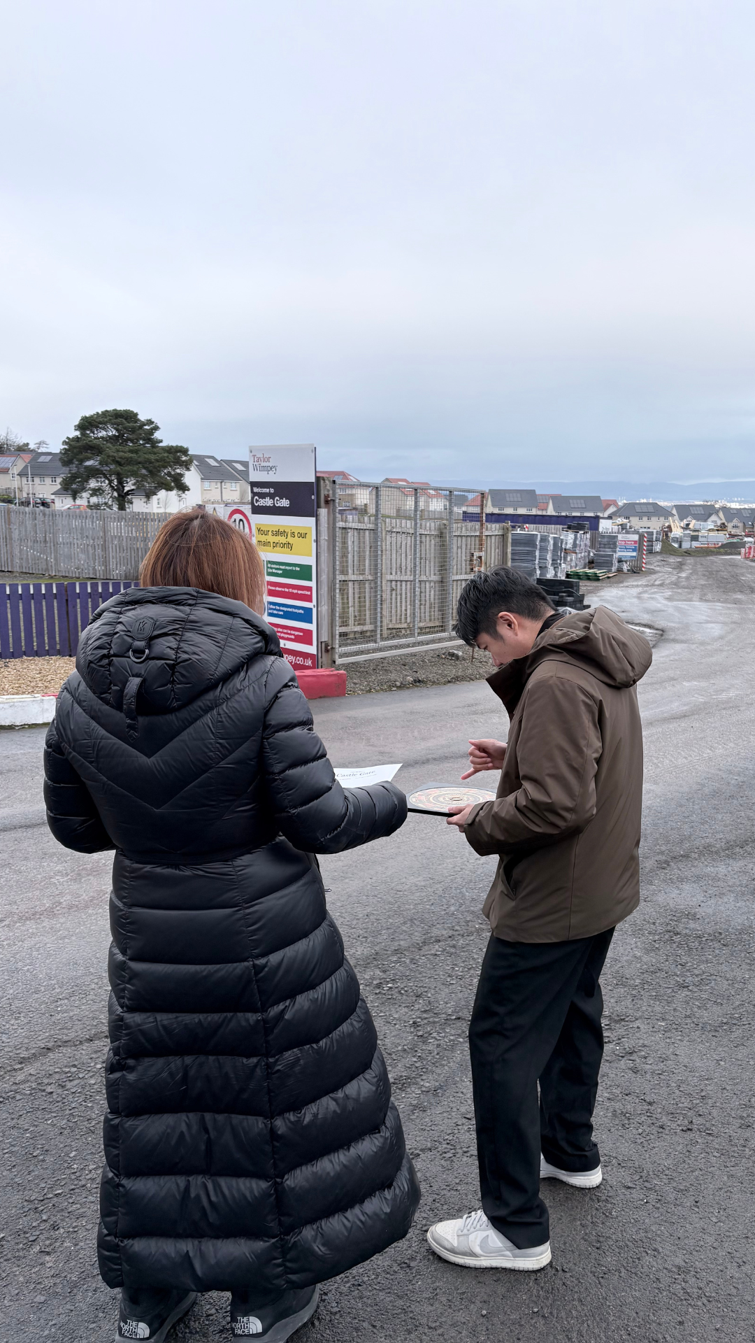 Daniel Siew reviewing a plan with a developer on site in Glasgow, Scotland